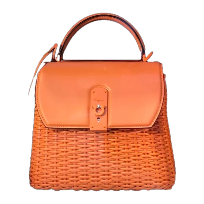 A leather top-handle bag, developing as its price is watched.